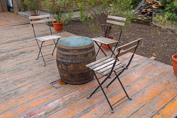 Wooden Barrel Table Chairs at Decking in Garden