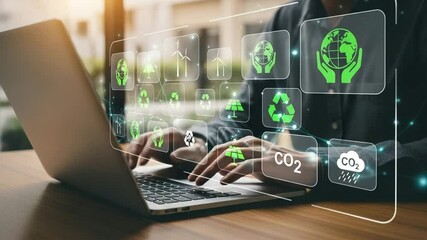 Person using laptop with green energy icons overlayed for sustainable technology solutions display - Powered by Adobe