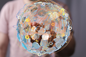 Person interacts with a digital globe, showing global networking and connections.