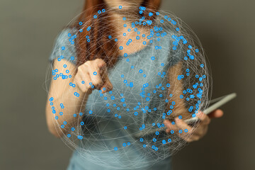 Female using tablet, interacting with a digital global network visualization. Technology concept.