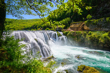 Amazing Strbacki buk waterfalls on river Una in Bosnia and Herzegovina. Beautiful nature in Una national park with crystal clear water and amazing cascade waterfalls.