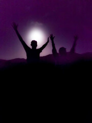 Fototapeta premium Silhouettes celebrating under full moon