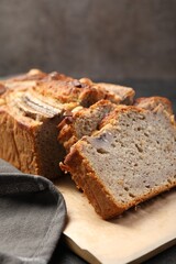 Cut banana bread with nuts on table, closeup