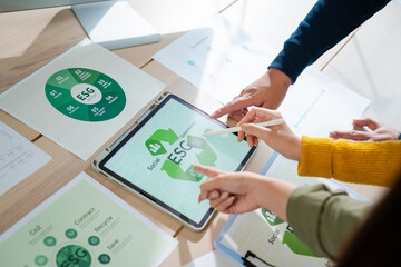 Young Asian business team discussion reusable product in office,start up eco-friendly business,environmental protection,sustainable business model,ESG strategy,team meeting,people work at home concept