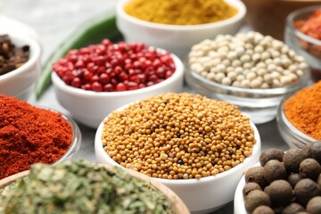 Different aromatic spices in bowls on table, closeup