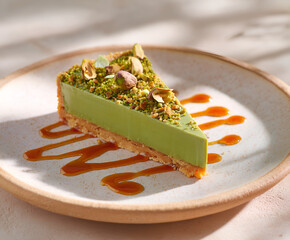 Pistachio tart with glossy sauce and crushed nuts