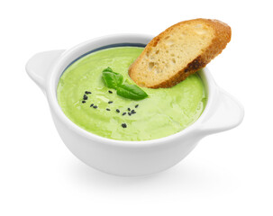 Tasty pea cream soup with basil and crouton isolated on white