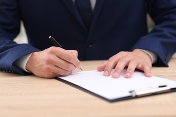 Judge working at wooden desk indoors, closeup