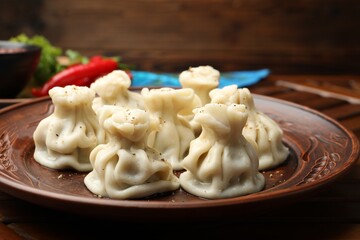 Delicious khinkali with spices on table, closeup