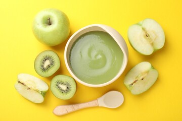 Baby food. Tasty puree in bowls and different ingredients on yellow background, flat lay