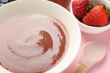 Baby food. Tasty puree in bowl and ingredients on pink background, closeup