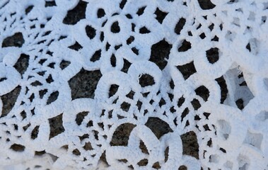 A close-up view of delicate white lace fabric