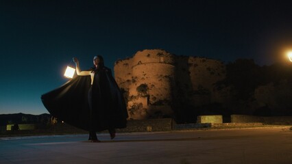 Woman With Cloak And Lantern Spins In A Circle Pirouette At Night Near A Castle © Polonio Video