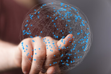 Abstract image of a hand interacting with a digital globe, representing global network connections...