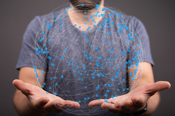 A man holds a digital globe representing global connections and networking.