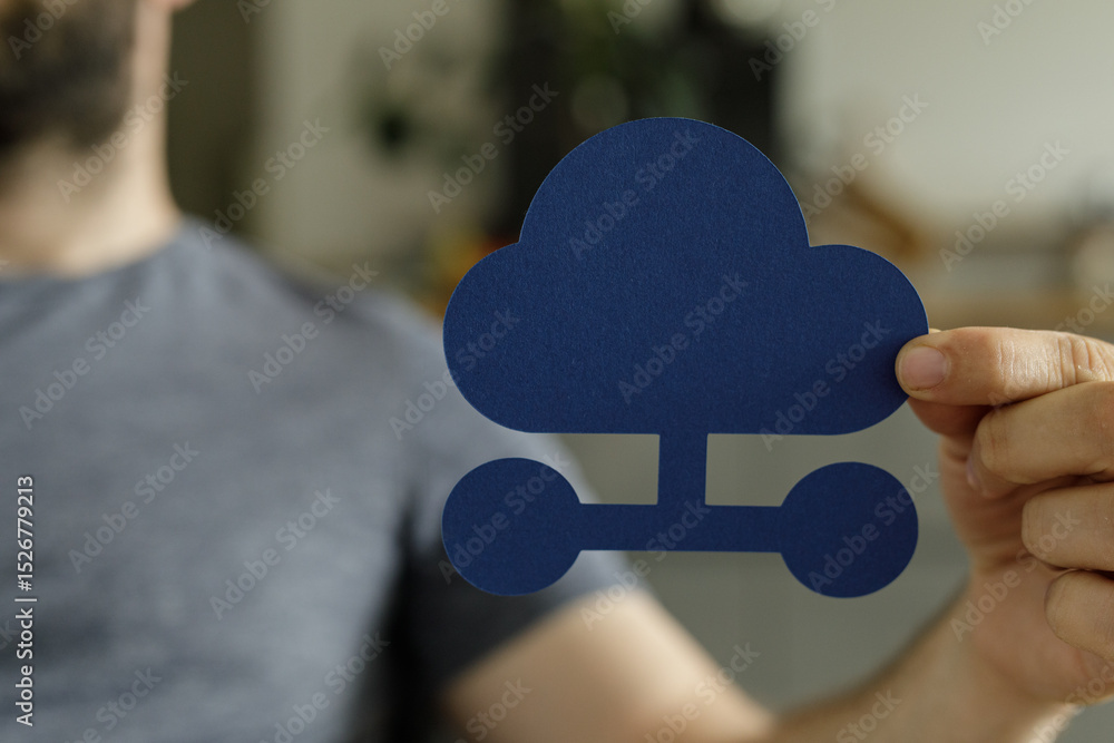 Poster close-up of a person holding a paper cutout of a cloud connected to a network, symbolizing cloud com