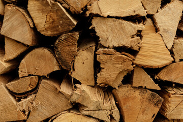 Close-up of neatly stacked firewood, perfect for winter warmth and cozy ambiance.  Ideal for blogs,...