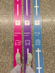Navigation signs on the floor of the Warsaw Chopin Airport: directions to the bus, intercity bus...