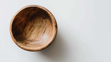 Empty wooden bowl with natural grain texture on a clean white background. Healthy eating and cooking concept with copy space.