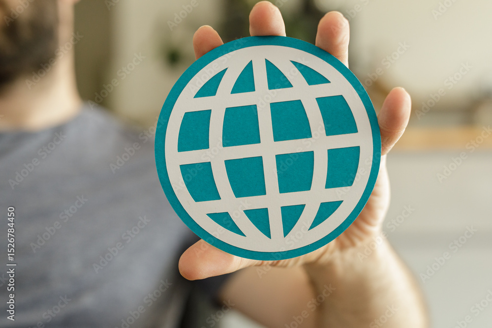 Aufkleber Close-up of a hand holding a teal globe icon, representing global connection and networking.