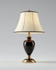 Elegant table lamp with a gold and black base and a cream-colored lampshade, set against a neutral background