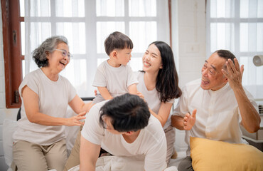 Fototapeta premium Family gathering in a bright room with laughter, love, and joyful interaction among generations