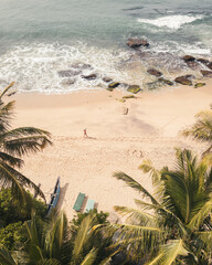 Aerial tow down view carefree woman alone enjoy beach walk on tropical beach holidays in asia.Solo travel vacation holidays in tropical island get away