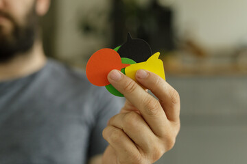 Stock photo of a person holding colorful speech bubbles, representing communication, dialogue, and...