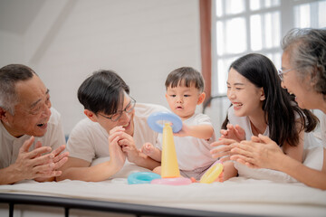 Family bonding time with a toddler playing and laughing together at home in a cozy setting