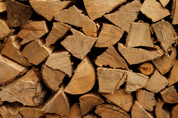 High-resolution image of neatly stacked firewood logs, perfect for autumn or winter themes.