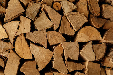 High-resolution image of neatly stacked firewood logs, perfect for autumn or winter themes.