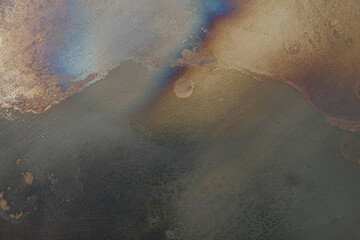 High-resolution image of a textured metal surface showing burn marks, scratches, and discoloration. Ideal for backgrounds or industrial designs.