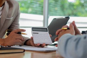 Professional real estate agents meet with clients in modern offices to discuss real estate investments, contracts, mortgage options, and sign documents for the purchase, sale, or new apartment loan 