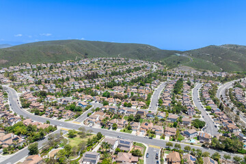 Aerial view of San Marcos neighborhood with houses and street during sunny day, South California, USA.