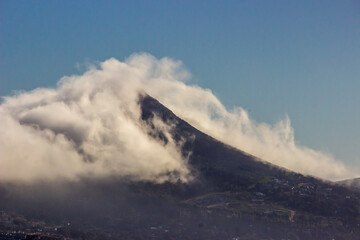 Cloud enveloping the peak of Klein Leeukop Mountain, along the southern South African coast.