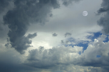 Sky with clouds and moon. Beautiful clouds in the sky. Daytime sky with full moon in the clouds. Soft focus.