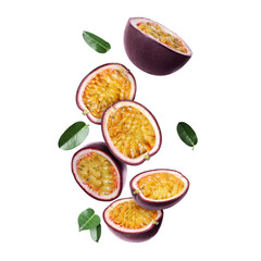 Delicious cut passion fruits and green leaves falling on white background