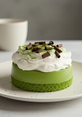 Matcha Green Tea Mousse Cake - Delicious matcha green tea mousse cake, topped with whipped cream and chocolate shavings. Perfect for a special treat