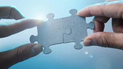 Hands connecting two parts jigsaw puzzle.Solution, problem solving,cooperation.Success concept. - Powered by Adobe