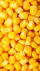 Fototapeta premium Fresh yellow corn kernels fill the frame, showcasing their glossy surface and vibrant color, ideal for various culinary uses, enhancing dishes with sweetness.