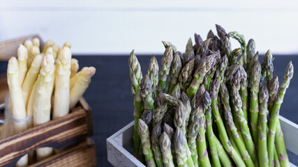 A visual contrast of green and white asparagus in rustic crates, ideal for spring harvest themes
