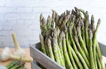 In a rustic gray crate Vibrant green asparagus, highlighting natural color and seasonal freshness
