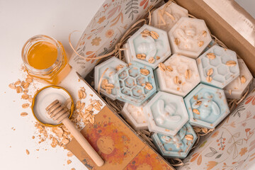 Handmade small honeycomb and bees oatmeal and honey soap bars in box. Aesthetic soap on white background with copy space