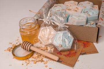 Handmade small honeycomb and bees oatmeal and honey soap bars in box. Aesthetic soap on white background with copy space