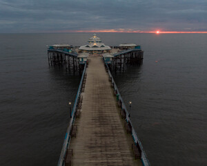 Obraz premium Drone image of Llandudno Pier at Sunrise, North Wales, UK