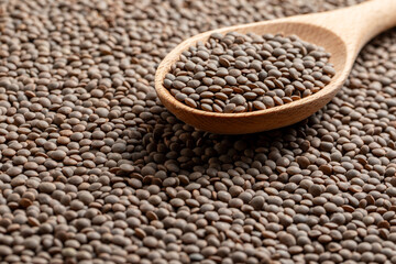 Lentils picked up by a wooden spoon