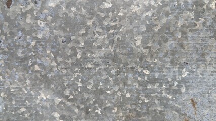 Close-up of textured galvanized metal surface with scratches and marks