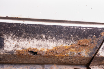 Rust and corrosion hole on an old car.