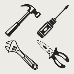 Black and white illustration of basic hand tools hammer screwdriver wrench pliers
