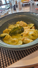 Exquisite Serving White Restaurant Plate of Ravioli 4 Cheeses with Cheese Espoume. Traditional Delicacy Italian Dumplings